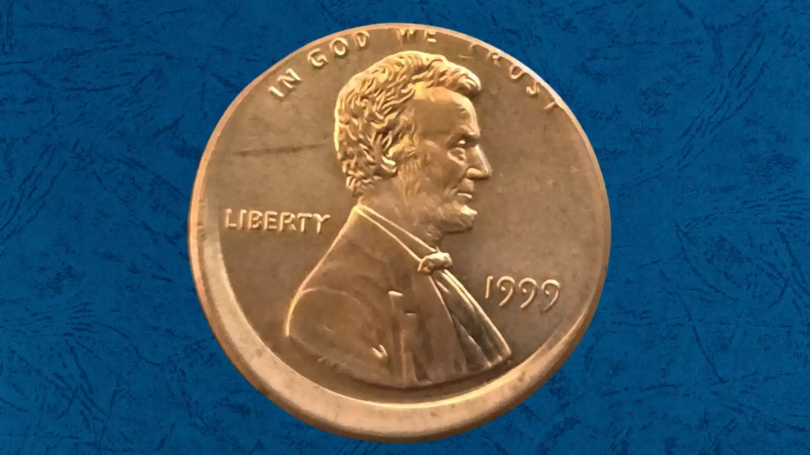 1999 penny off-center strike error showing Lincoln's portrait shifted off-center with blank planchet crescent visible